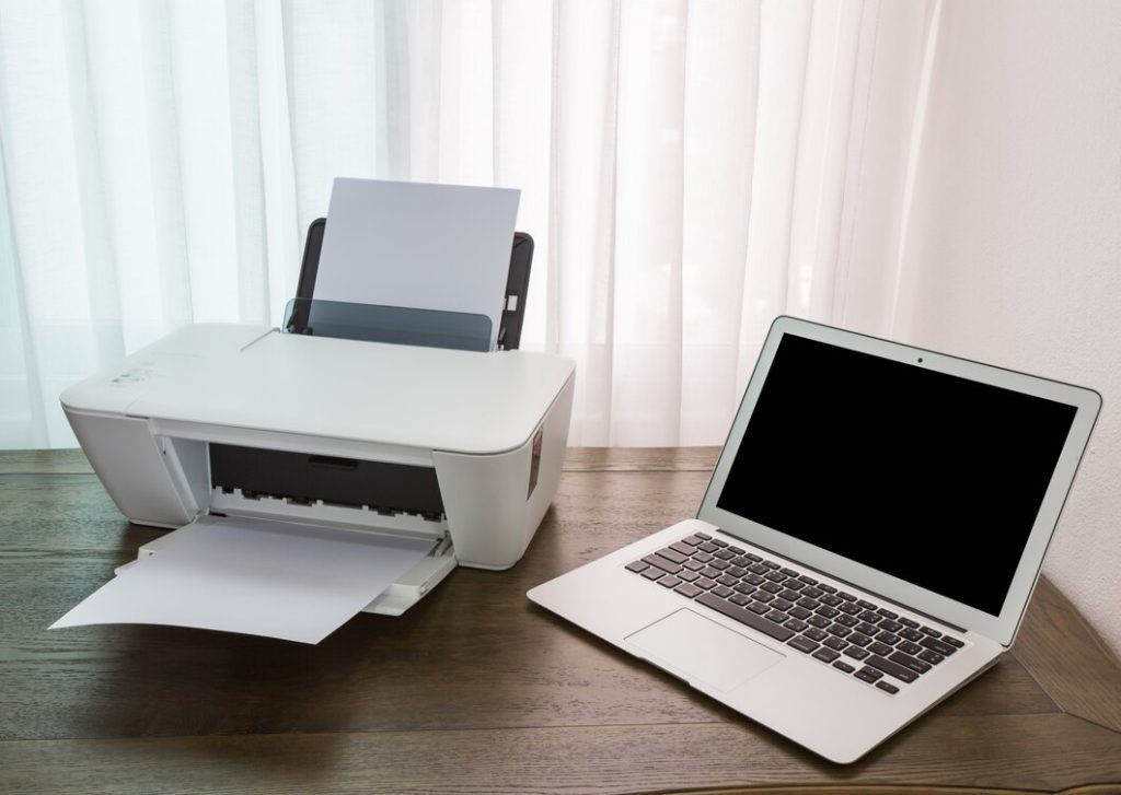 laptop-wooden-table-with-printer_1232-568